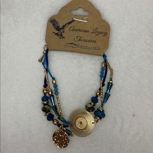 Pretty blue glass  beaded with gold tone charm.